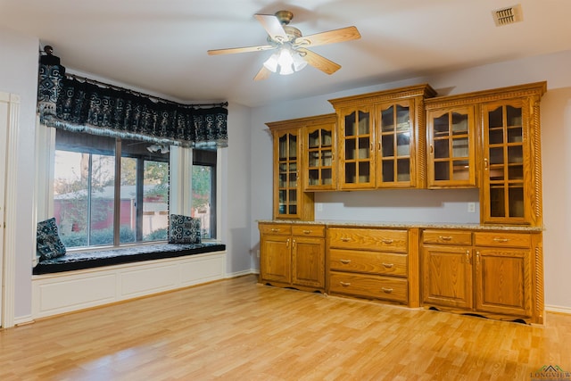 kitchen with ceiling fan and light hardwood / wood-style flooring