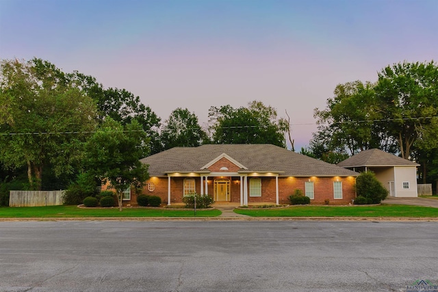 ranch-style home with a yard