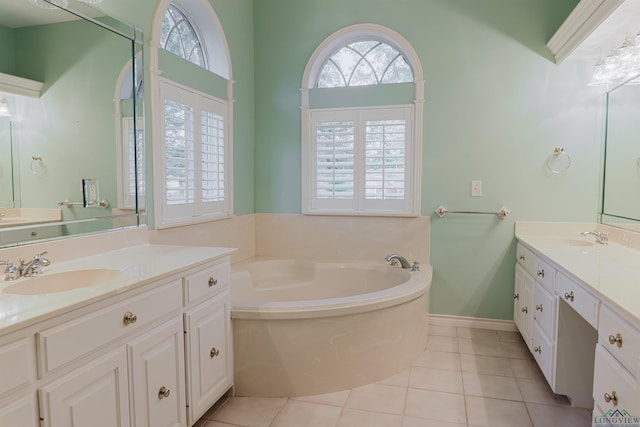 bathroom featuring tile patterned floors, vanity, and a tub