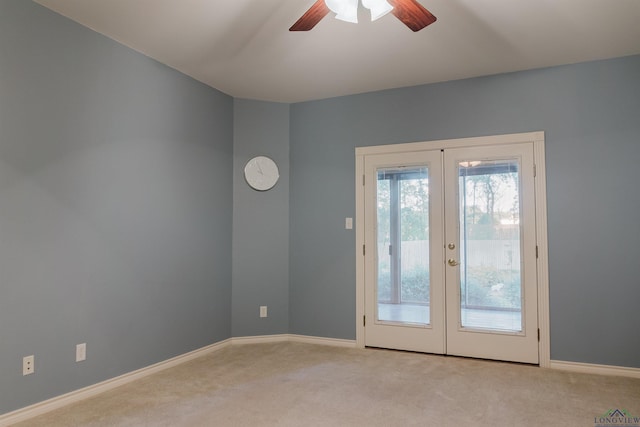 doorway to outside with ceiling fan, light colored carpet, and french doors