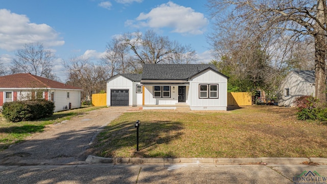 view of front of property featuring a garage and a front yard