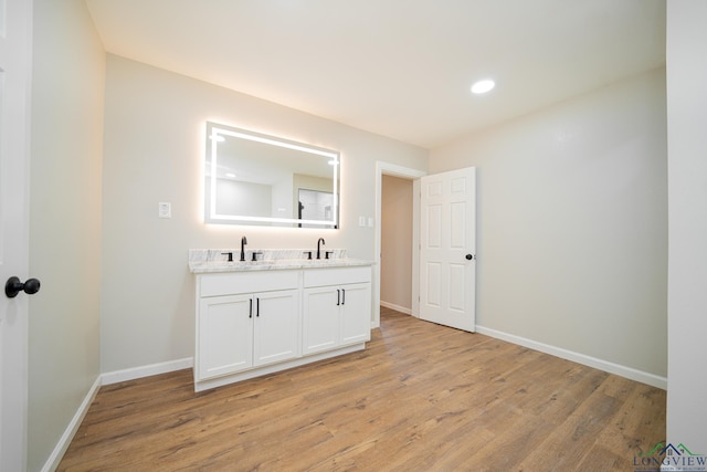 bathroom featuring hardwood / wood-style flooring and vanity