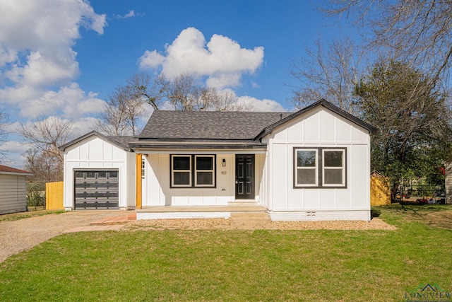 modern farmhouse with a garage, a front yard, and covered porch