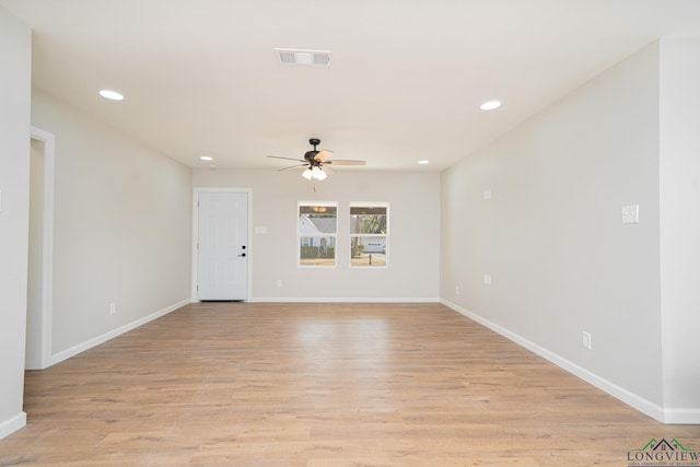 empty room featuring ceiling fan and light hardwood / wood-style floors