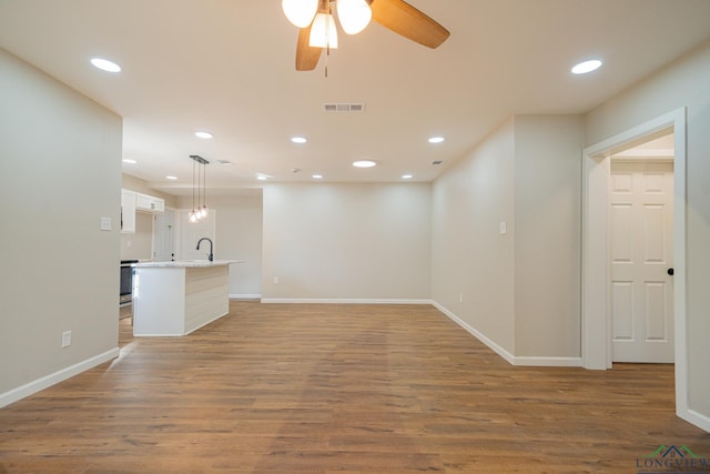 interior space with hardwood / wood-style floors and ceiling fan