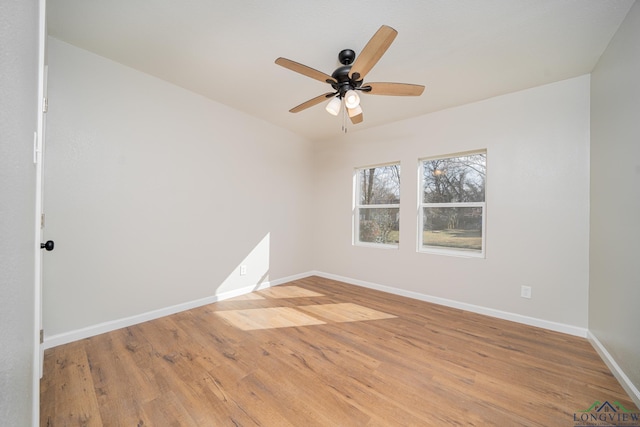 empty room with ceiling fan and light hardwood / wood-style flooring