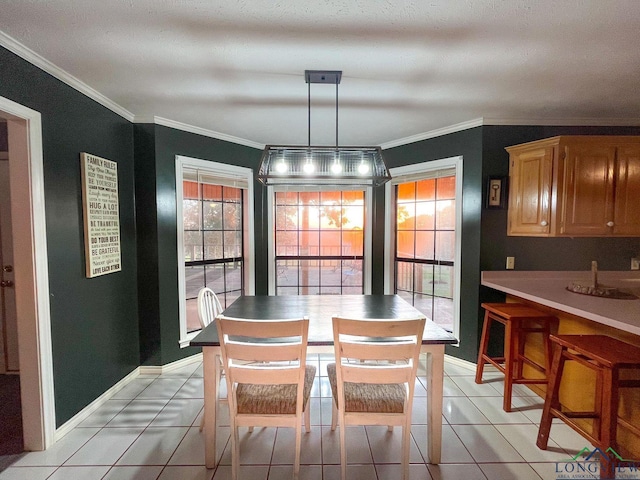 dining room featuring light tile patterned floors and crown molding