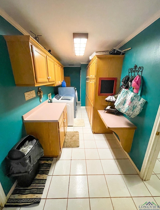 laundry room with washer and dryer, cabinets, light tile patterned floors, and ornamental molding