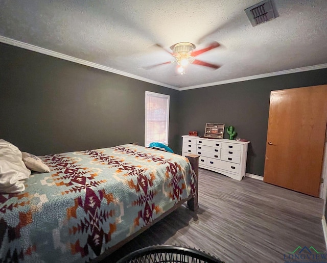 bedroom with a textured ceiling, ceiling fan, crown molding, and dark wood-type flooring