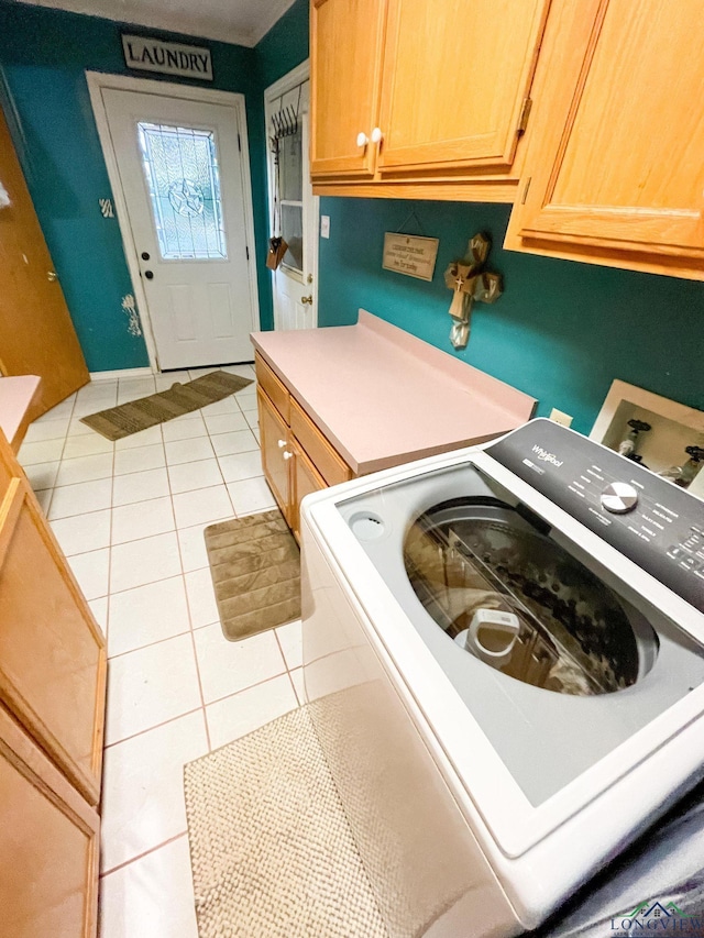 clothes washing area with cabinets, washer hookup, and light tile patterned flooring