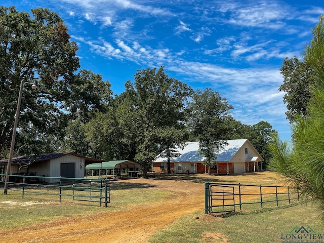 view of yard featuring an outbuilding and a rural view