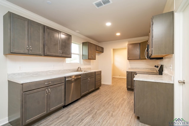 kitchen with appliances with stainless steel finishes, light countertops, visible vents, and dark brown cabinets