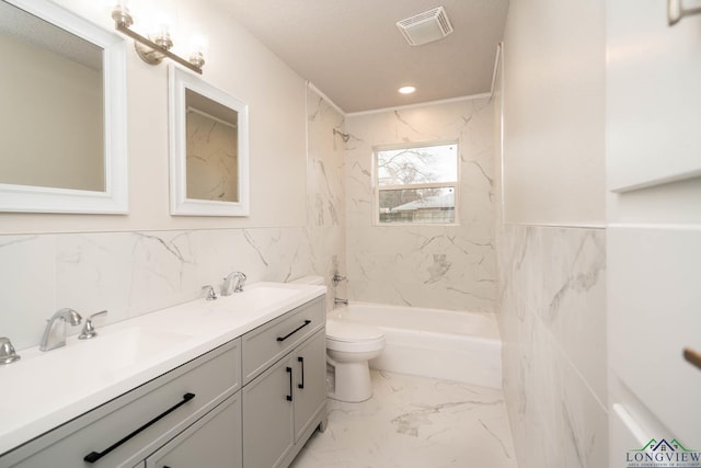 full bathroom with marble finish floor, visible vents, a sink, and tub / shower combination