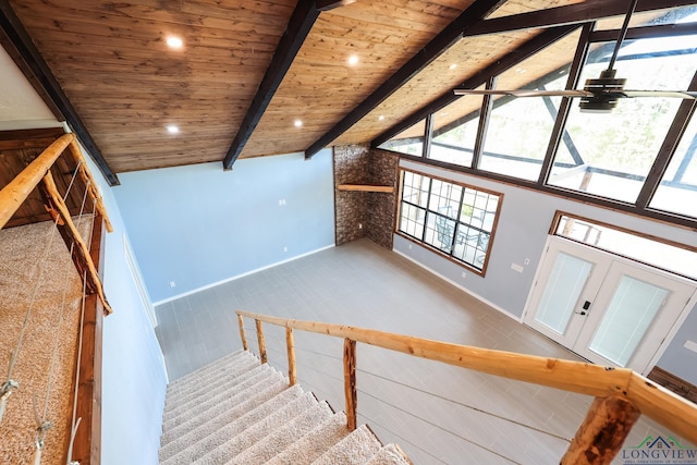 stairs featuring lofted ceiling with beams, ceiling fan, and wooden ceiling