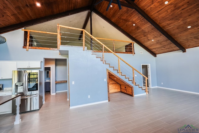 unfurnished living room featuring beamed ceiling, light tile patterned floors, wooden ceiling, and high vaulted ceiling