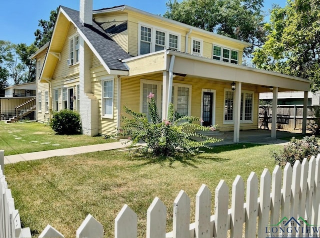 view of front of home with a front yard, a chimney, cooling unit, roof with shingles, and fence