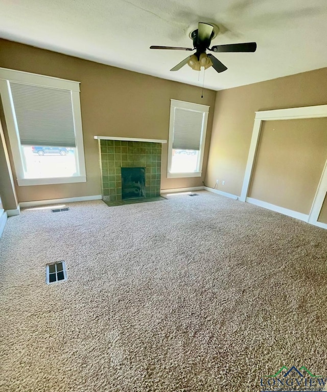 unfurnished living room with baseboards, a ceiling fan, and carpet floors