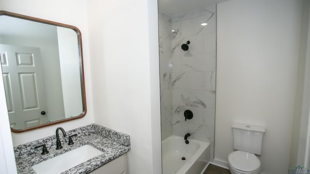 full bathroom featuring tiled shower / bath combo, toilet, and vanity