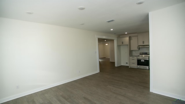 spare room with dark hardwood / wood-style flooring