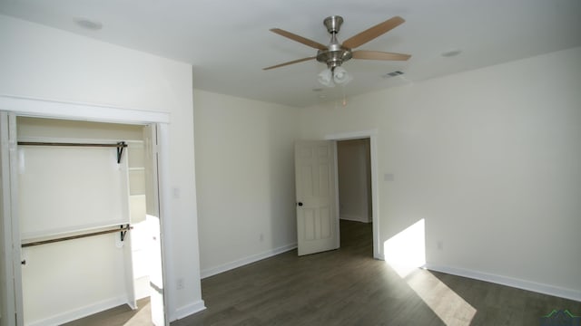 unfurnished bedroom with ceiling fan, dark hardwood / wood-style flooring, and a closet