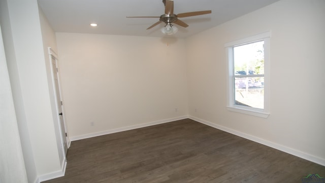 empty room with ceiling fan and dark hardwood / wood-style flooring