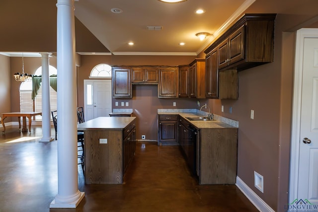 kitchen featuring ornate columns, a chandelier, ornamental molding, a kitchen island, and sink