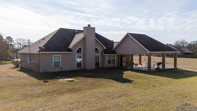 rear view of property featuring a patio area and a lawn