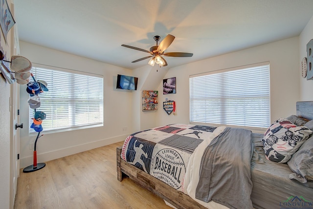 bedroom featuring baseboards, a ceiling fan, and wood finished floors
