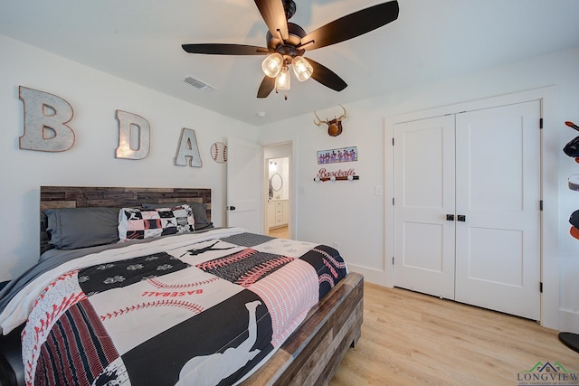 bedroom featuring a closet, light wood finished floors, a ceiling fan, and visible vents