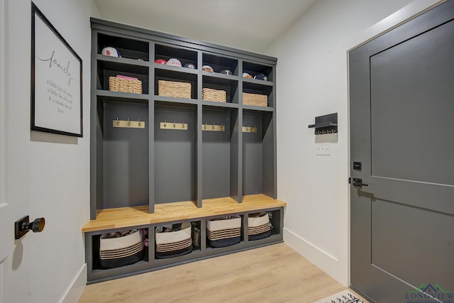 mudroom with wood finished floors and baseboards