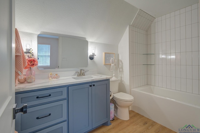 full bath with toilet, wood finished floors, vanity, and vaulted ceiling