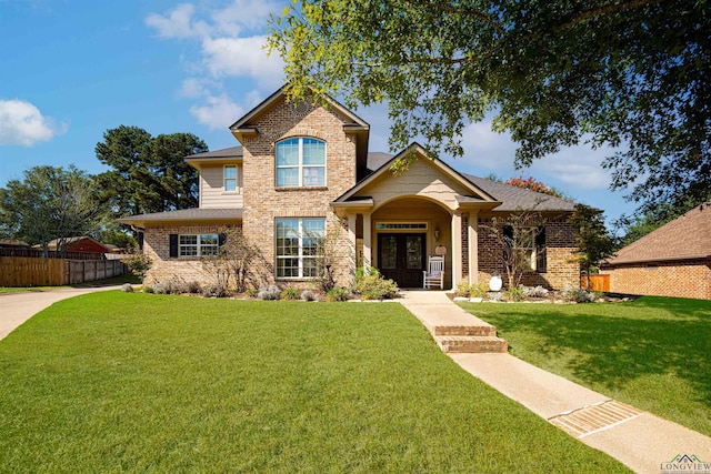 view of front facade featuring a front yard and french doors