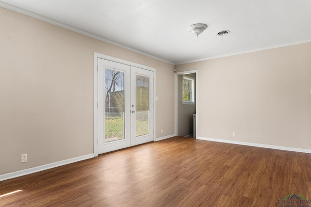 unfurnished room featuring wood finished floors, crown molding, and french doors