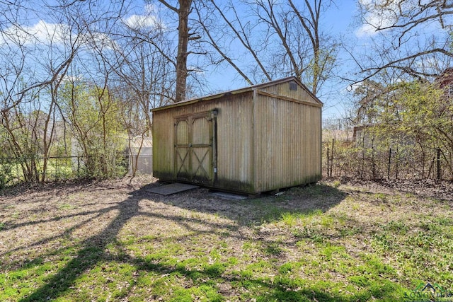 view of shed featuring fence