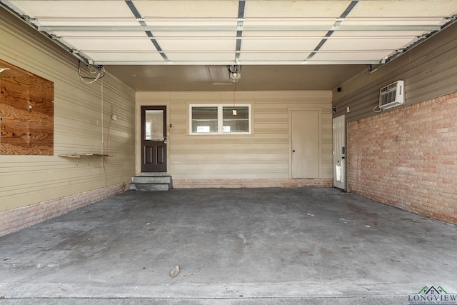 garage featuring a garage door opener and a wall unit AC