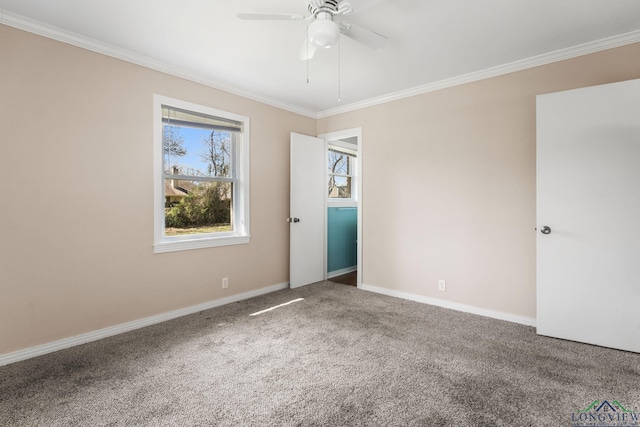 carpeted spare room featuring ceiling fan, baseboards, and ornamental molding