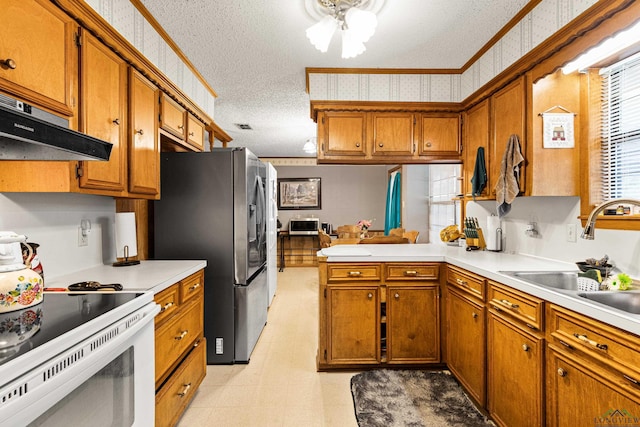 kitchen featuring exhaust hood, electric stove, sink, stainless steel fridge, and a textured ceiling