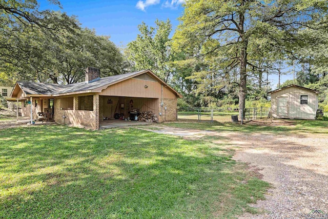 exterior space with a lawn and a shed