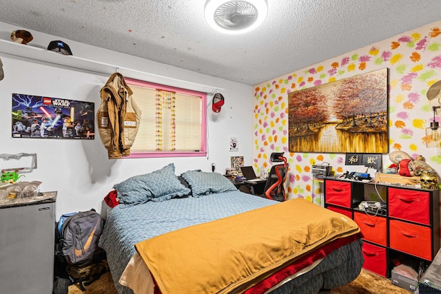 bedroom with carpet flooring and a textured ceiling