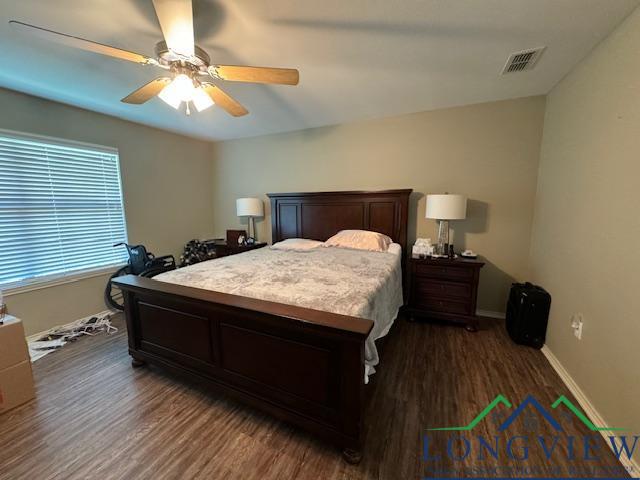 bedroom with ceiling fan and dark wood-type flooring