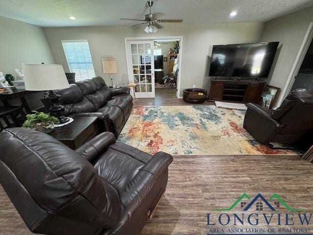 living room featuring hardwood / wood-style flooring, ceiling fan, and french doors