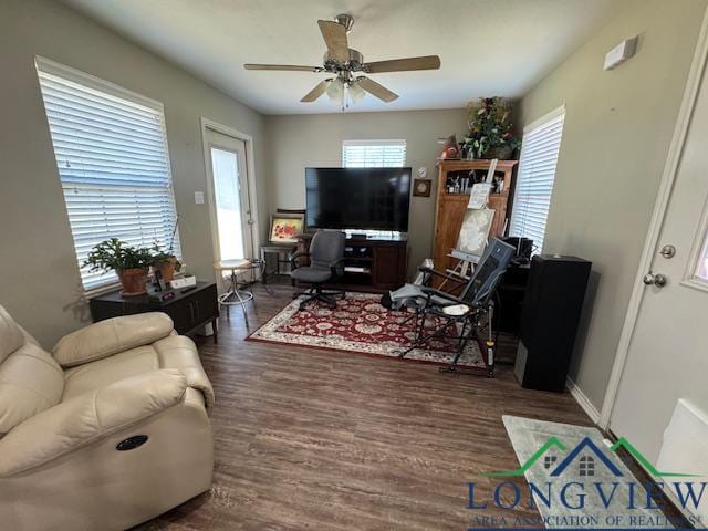 living room featuring ceiling fan, plenty of natural light, and dark hardwood / wood-style floors