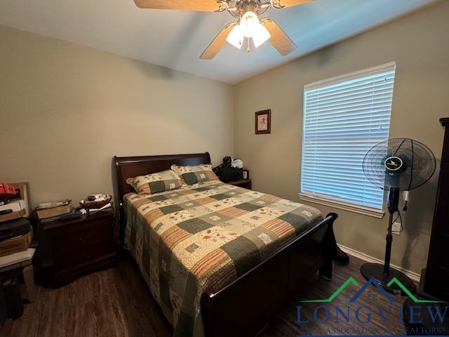 bedroom featuring ceiling fan and dark wood-type flooring