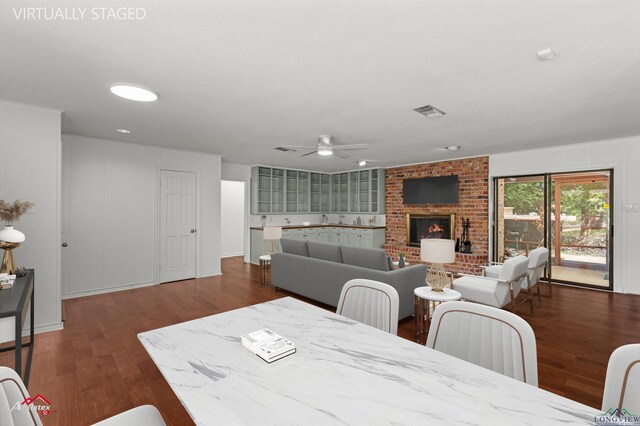 2804 Palm Plz, Marshall, TX 75672 - dining room with ceiling fan, a fireplace, and wood finished floors
