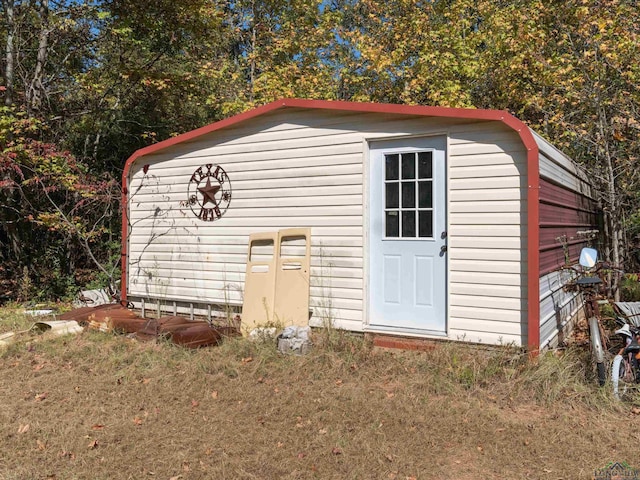 view of outbuilding featuring a yard