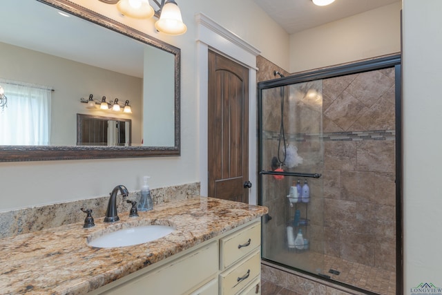 bathroom with vanity and a shower with shower door