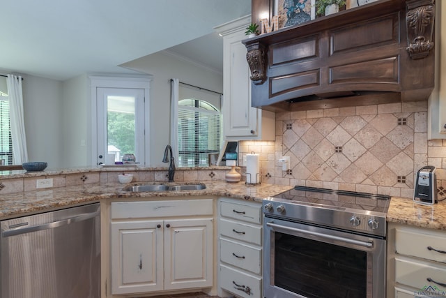 kitchen with tasteful backsplash, custom exhaust hood, stainless steel appliances, sink, and white cabinetry