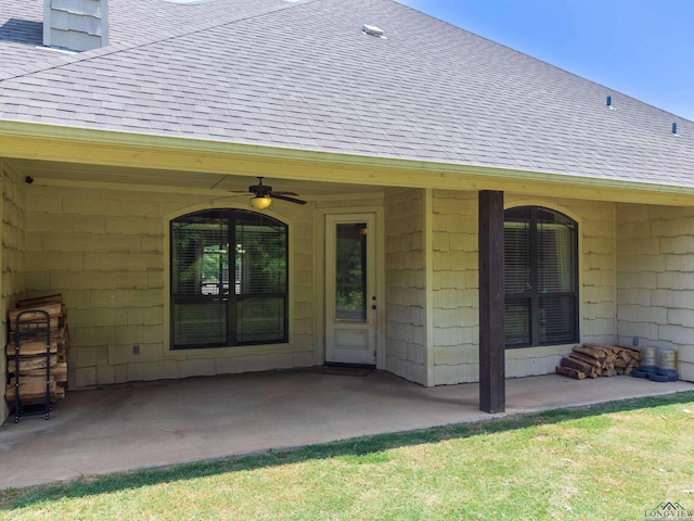 view of exterior entry featuring a patio area and ceiling fan