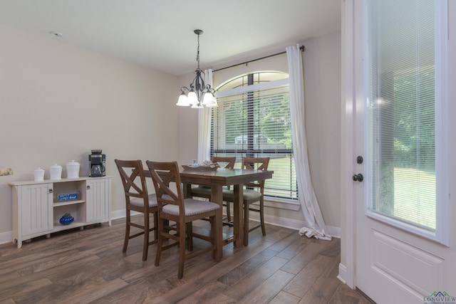 dining space with a notable chandelier and dark wood-type flooring