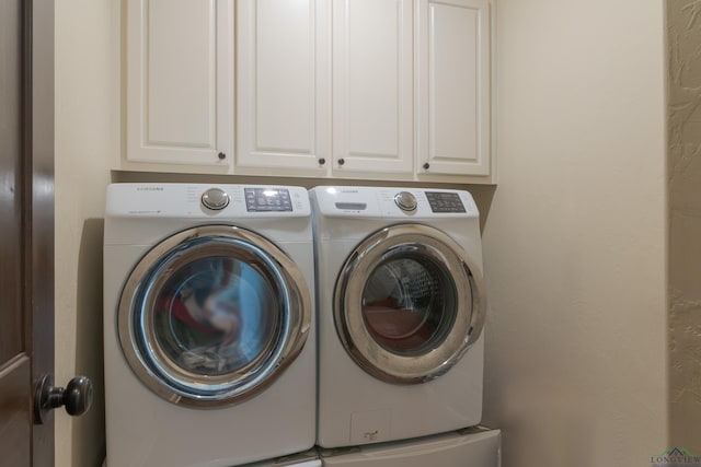 clothes washing area featuring separate washer and dryer and cabinets